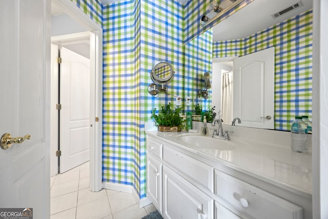 bathroom with tile patterned floors and vanity