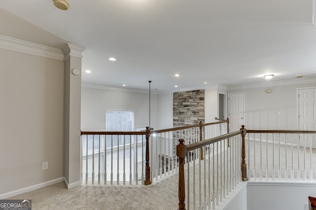 hallway with crown molding and carpet floors