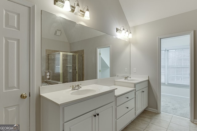 bathroom with lofted ceiling, vanity, tile patterned flooring, and a shower with shower door