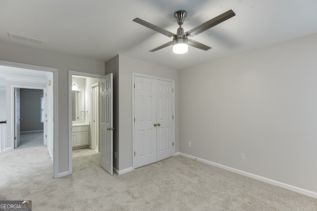 unfurnished bedroom featuring light carpet, a closet, and ceiling fan