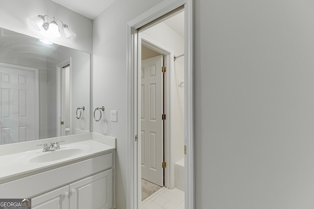 bathroom with shower / tub combination, vanity, and tile patterned flooring