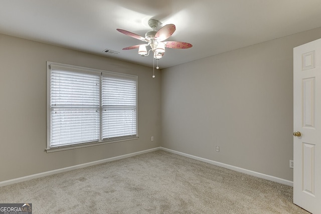 unfurnished room with light colored carpet and ceiling fan