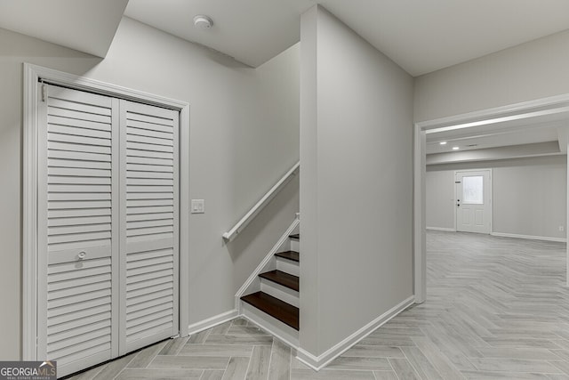 stairway featuring parquet floors