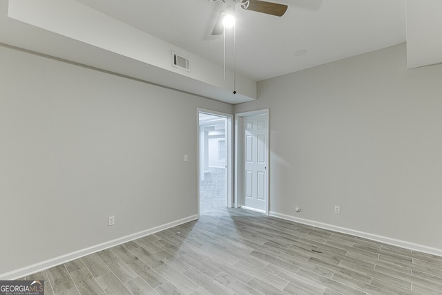 spare room featuring ceiling fan and light hardwood / wood-style floors