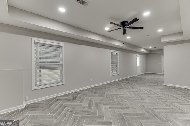 basement with light parquet floors and ceiling fan