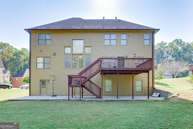 back of property with a patio, a wooden deck, and a lawn