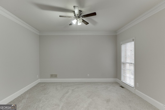 carpeted empty room featuring ceiling fan and ornamental molding