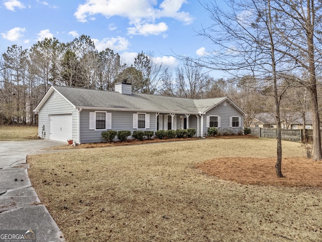 ranch-style home featuring a garage and a front lawn