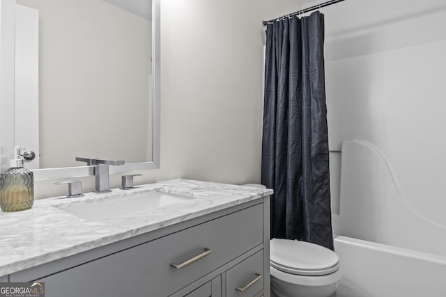 full bathroom with shower / tub combo with curtain, vanity, and toilet