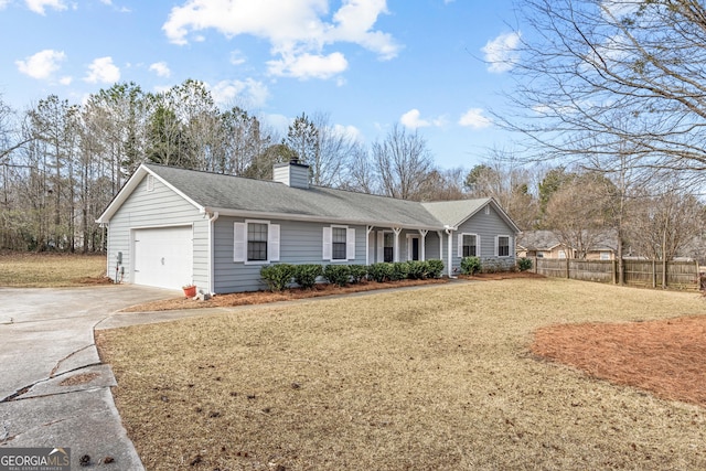 ranch-style house with a garage and a front lawn