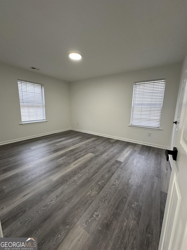 spare room with dark hardwood / wood-style flooring