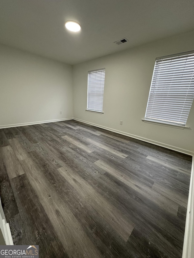 spare room featuring dark hardwood / wood-style flooring