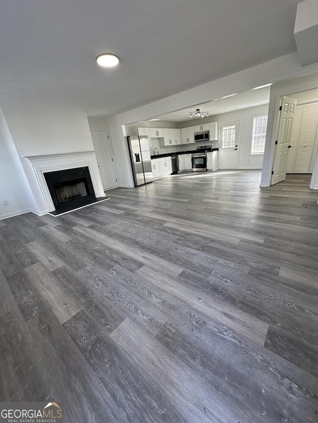 unfurnished living room featuring dark hardwood / wood-style flooring