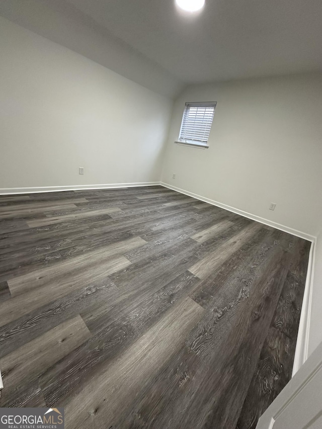 empty room featuring dark wood-type flooring