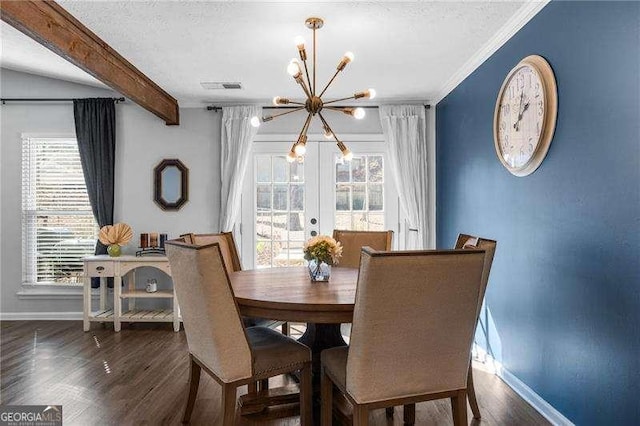 dining room with french doors, a healthy amount of sunlight, beam ceiling, and an inviting chandelier