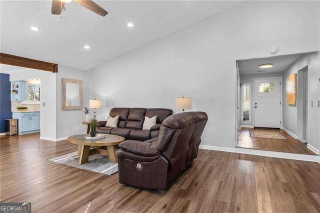 living room with high vaulted ceiling, dark hardwood / wood-style floors, and ceiling fan