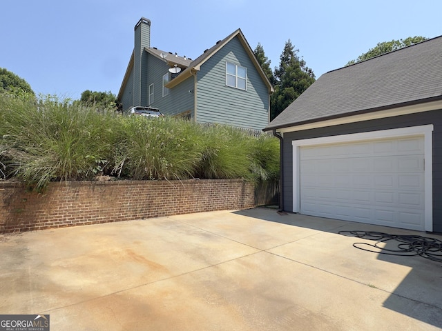 view of side of home featuring a garage