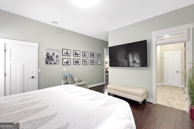 bedroom with dark hardwood / wood-style flooring