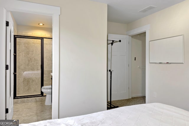 tiled bedroom featuring connected bathroom