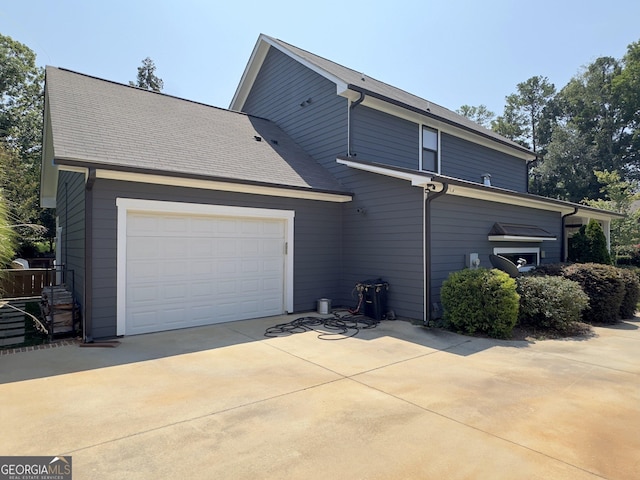 10 Plum Blossom Ln, Hampton, GA 30228 - rear view of house with driveway and an attached garage