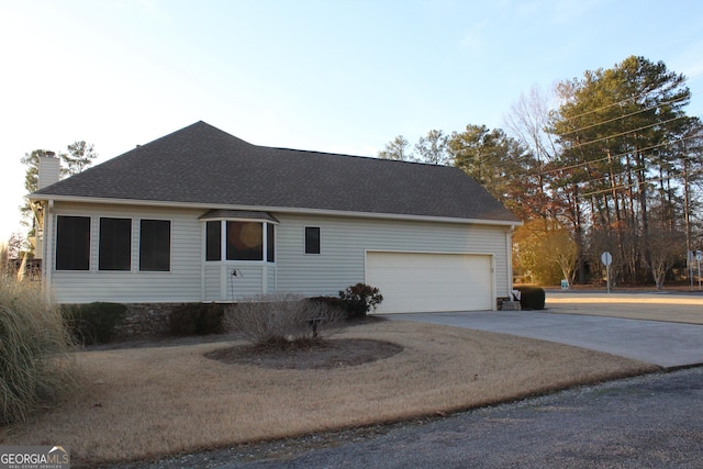 view of side of home featuring a garage