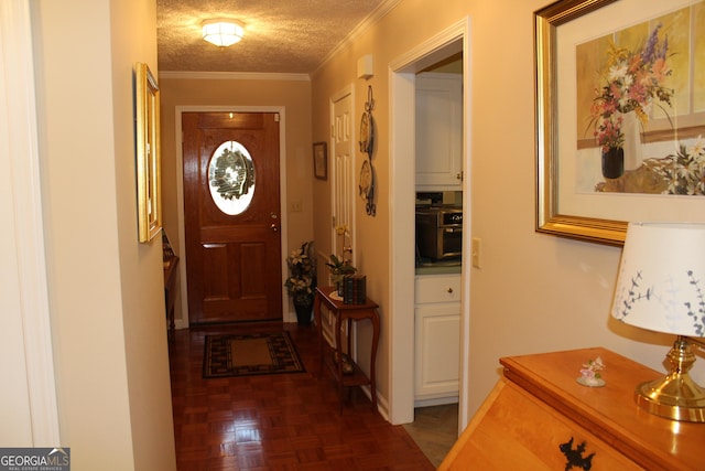 doorway featuring dark parquet flooring, ornamental molding, and a textured ceiling