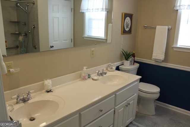 bathroom featuring vanity, toilet, and a shower