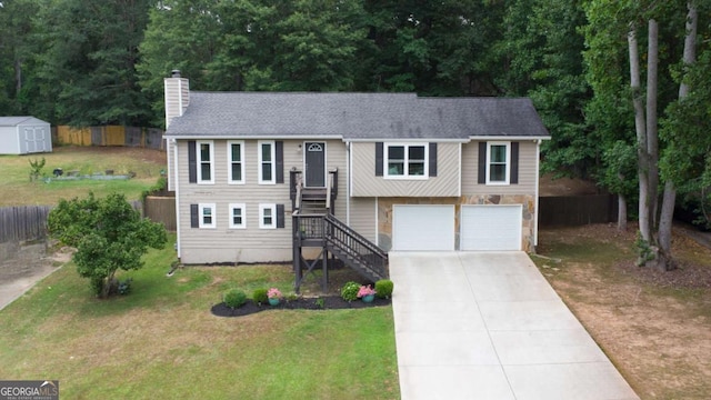 bi-level home featuring a garage and a front yard