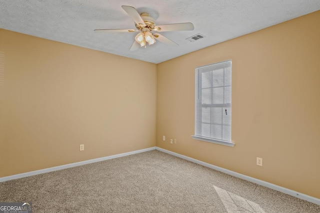 carpeted empty room featuring a textured ceiling and ceiling fan