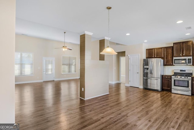 kitchen featuring decorative light fixtures, dark wood-type flooring, ceiling fan, and appliances with stainless steel finishes