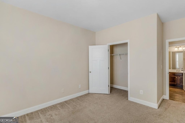 unfurnished bedroom featuring light colored carpet and a closet