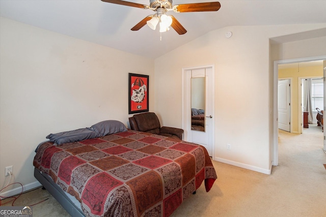 bedroom featuring lofted ceiling, light colored carpet, and ceiling fan