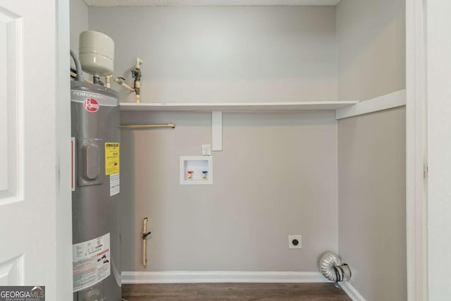 laundry area featuring dark hardwood / wood-style flooring, hookup for an electric dryer, hookup for a washing machine, and electric water heater