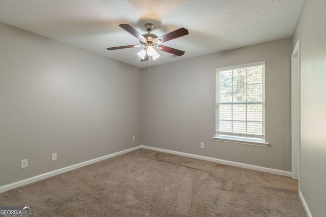 unfurnished room with ceiling fan, carpet floors, and a textured ceiling