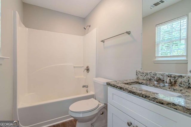 full bathroom with shower / tub combination, vanity, toilet, and hardwood / wood-style floors