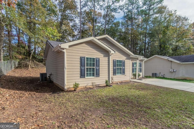 view of front of house featuring central AC unit and a front lawn