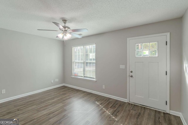 entryway with dark hardwood / wood-style floors, a textured ceiling, and ceiling fan