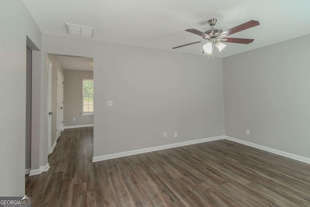 spare room with ceiling fan, dark hardwood / wood-style flooring, and a textured ceiling