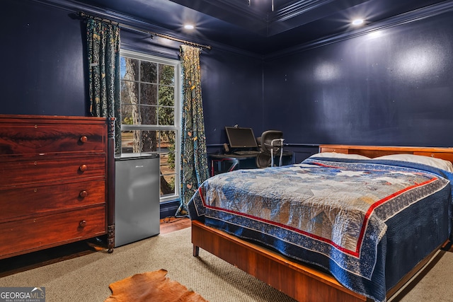 bedroom with crown molding and stainless steel refrigerator