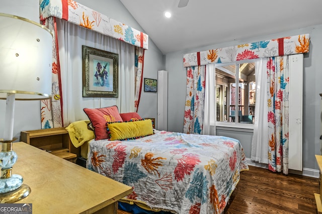 bedroom featuring dark wood-type flooring and vaulted ceiling