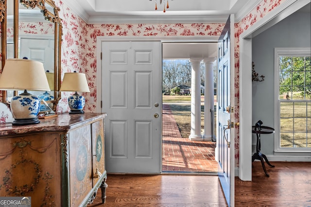 entryway with ornamental molding, hardwood / wood-style floors, and ornate columns