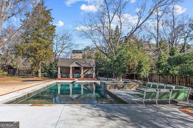 view of pool with a hot tub, a patio, and an outdoor structure