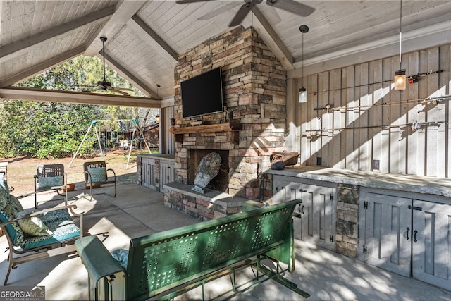 view of patio / terrace with a gazebo, ceiling fan, a playground, and an outdoor stone fireplace