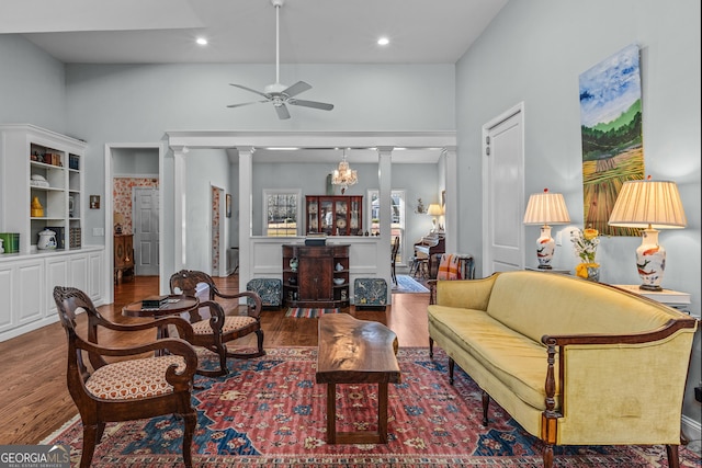 living room with ornate columns, wood-type flooring, and ceiling fan