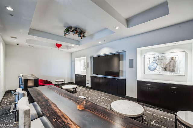 living room featuring a raised ceiling