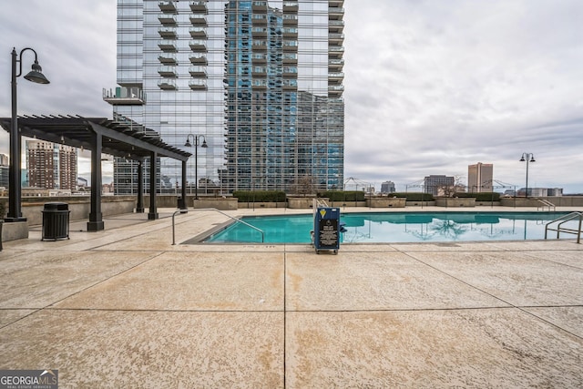 view of pool featuring a pergola and a patio