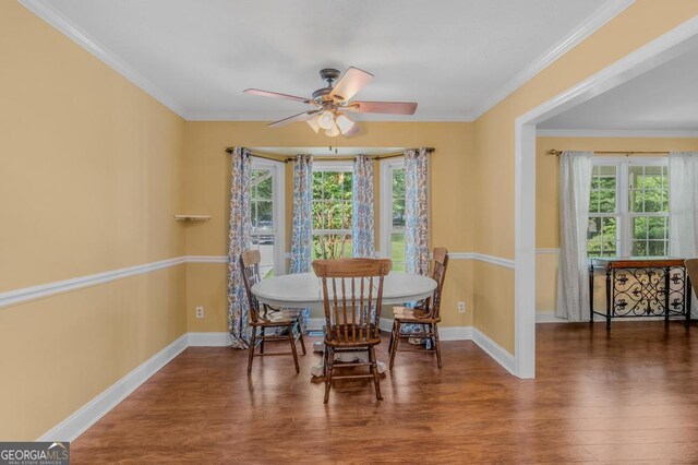 dining space featuring a healthy amount of sunlight, dark hardwood / wood-style floors, and ornamental molding