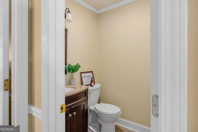 bathroom featuring vanity, ornamental molding, and toilet