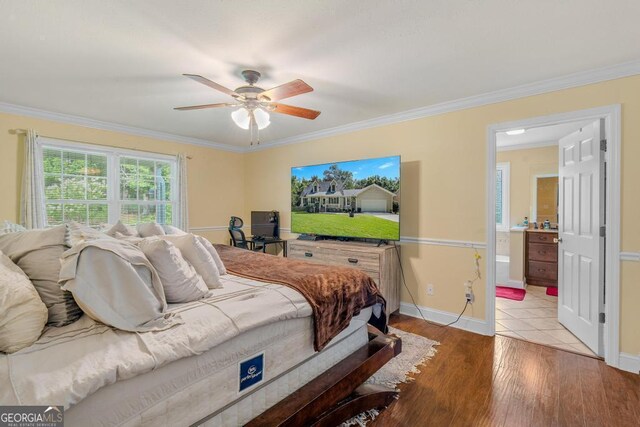 bedroom featuring crown molding, ceiling fan, connected bathroom, and light hardwood / wood-style flooring