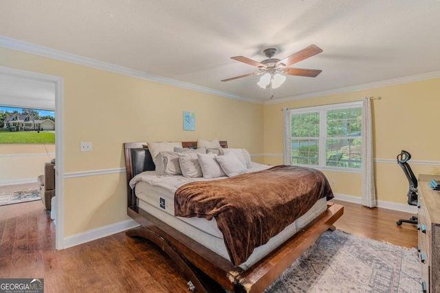 bedroom with hardwood / wood-style floors, crown molding, and ceiling fan